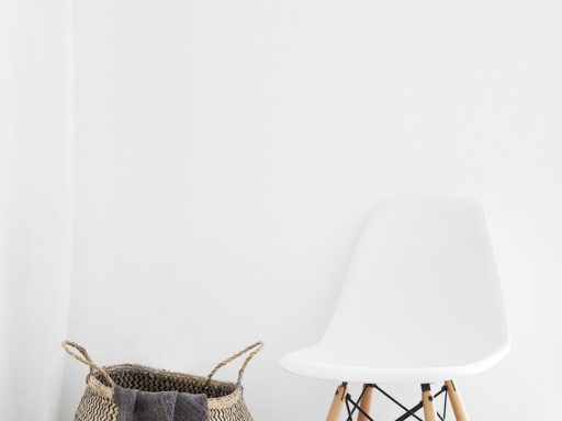 white and brown chairs beside wicker basket near white wall