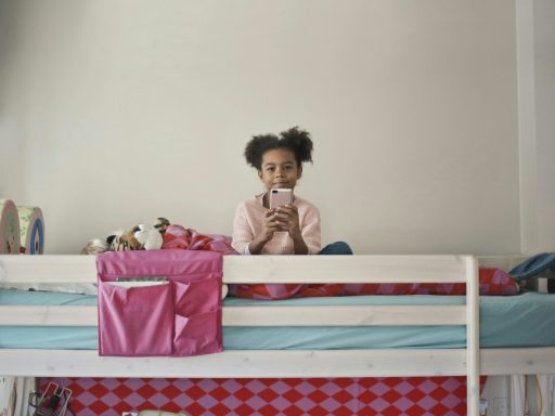 woman in yellow long sleeve shirt sitting on bed