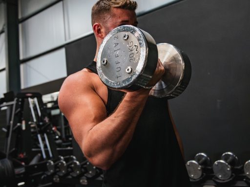 a man lifting a dumbbell in a gym