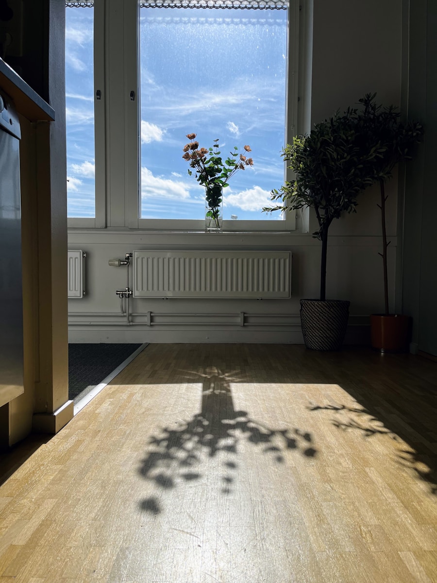 a tree casts a shadow on a wooden floor