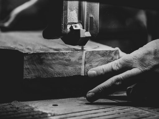 grayscale photography of person cutting slab