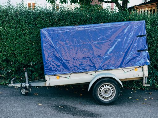 a trailer with a blue tarp on the back of it