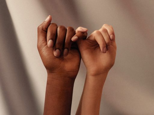 persons hand with white manicure