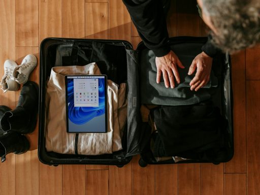 an overhead view of a person packing a suitcase