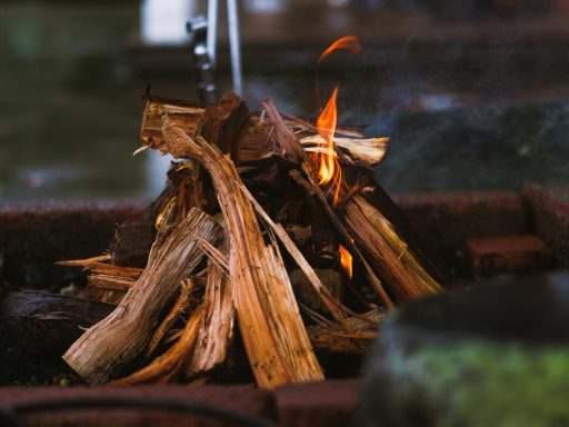 A warm glow from a crackling indoor wood fire, perfect for a cozy setting.