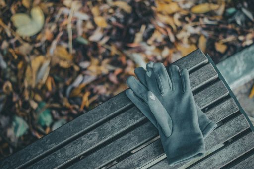 persons feet on brown wooden bench