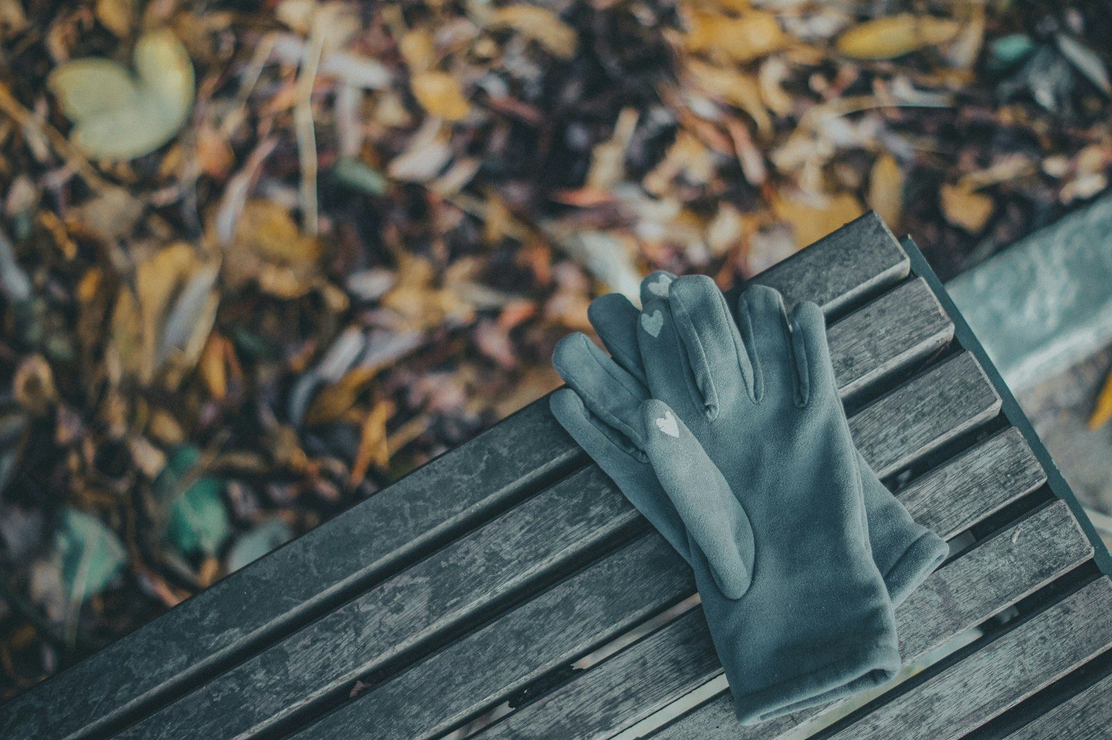 persons feet on brown wooden bench