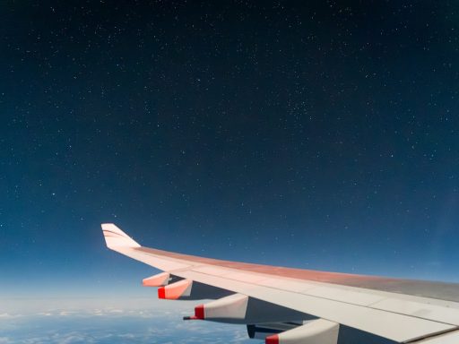 Airplane wing against a starry night sky