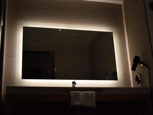 Verlichte badkamerspiegel met frontverlichting boven een wastafel